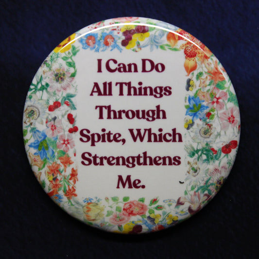 Decorative button with floral border and motivational quote on a dark background