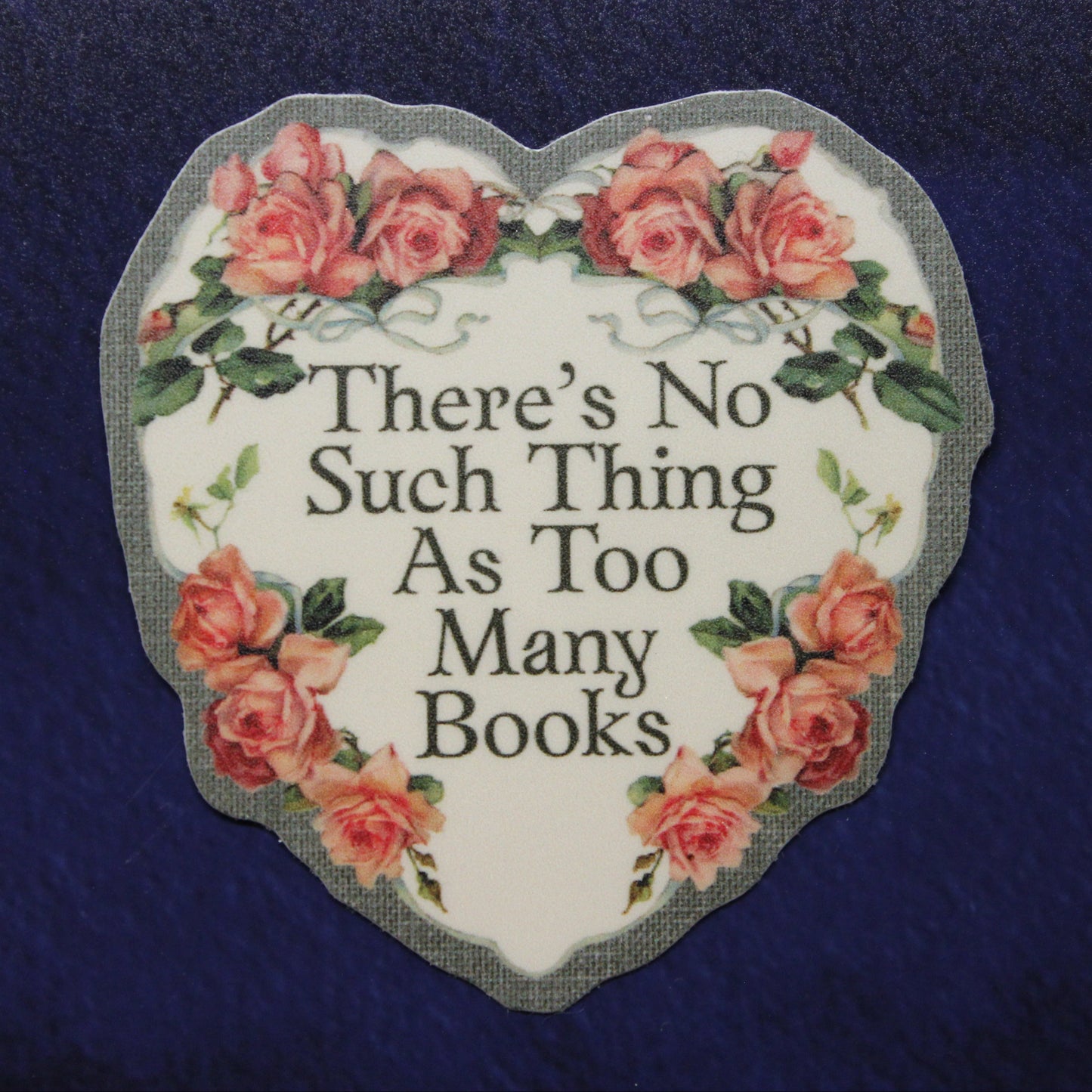 Heart-shaped sign with floral design and text on a blue background